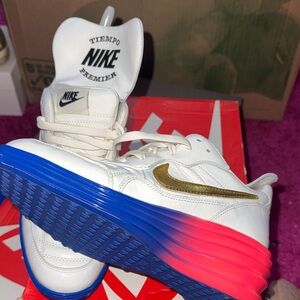 Nike White Leather Sneakers with Gold Swoosh and Blue-Pink Gradient Sole